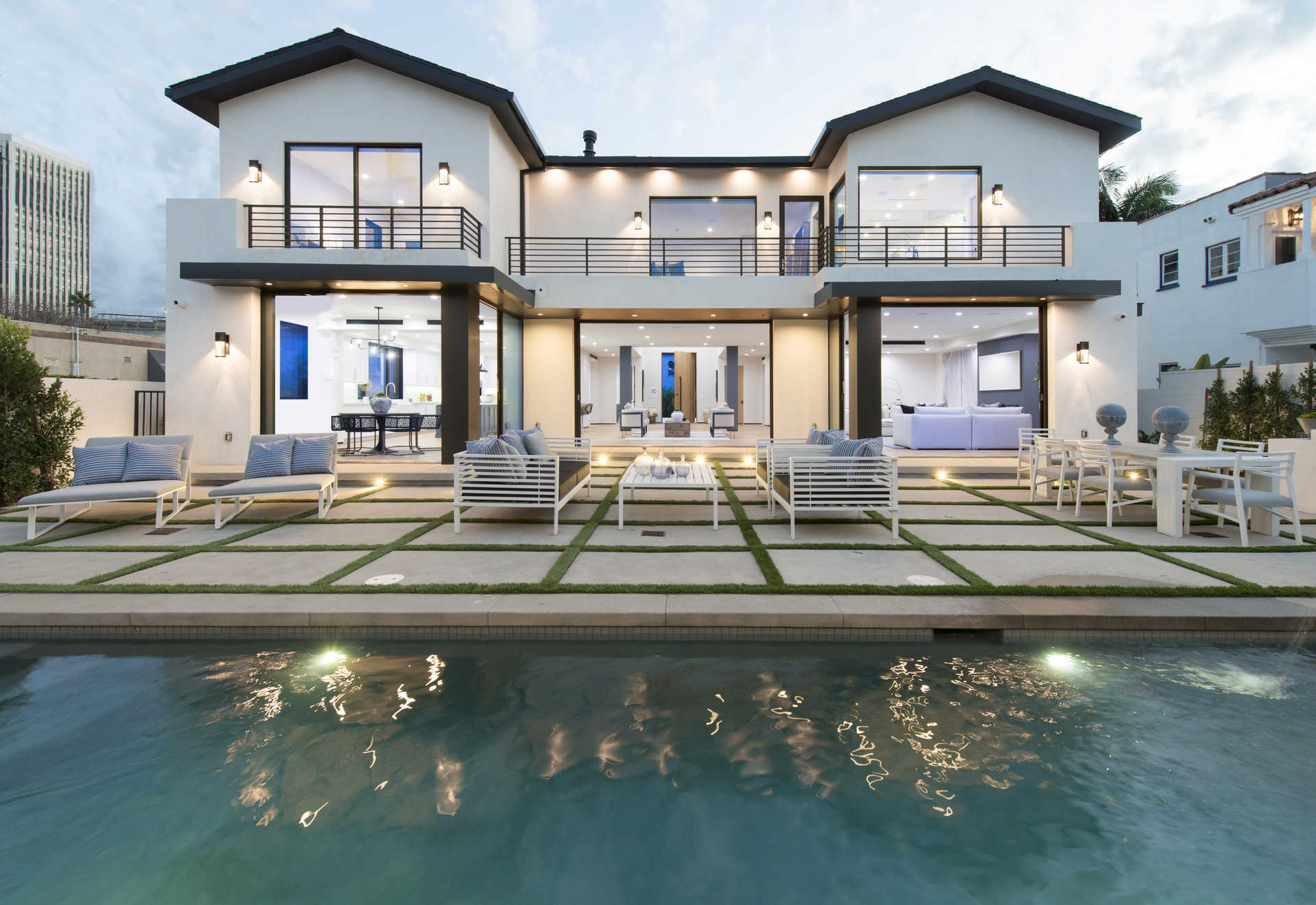 Rear elevation with pool, indoor-outdoor great room, and patio