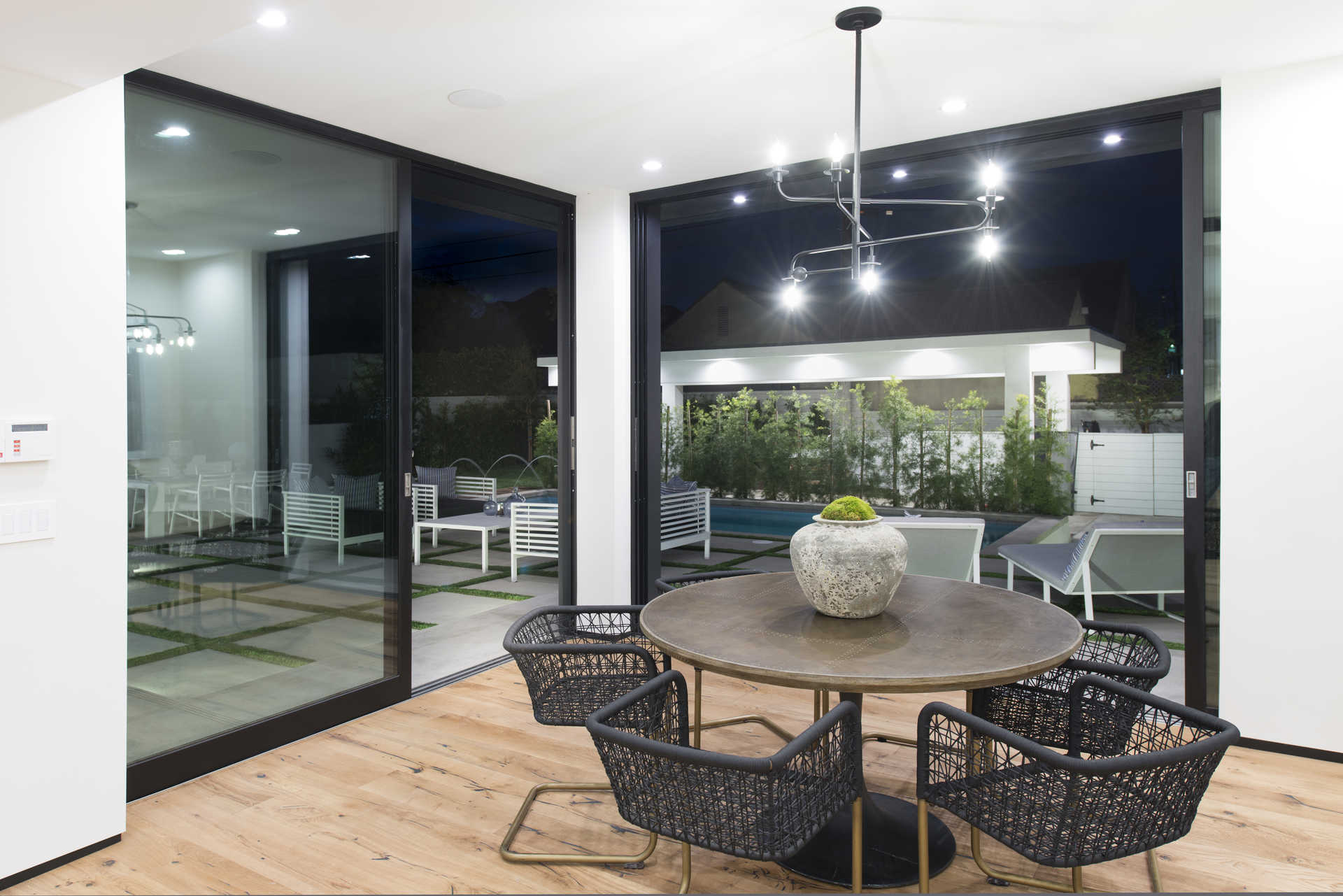 Breakfast nook with round table and full-height sliding glass to the patio