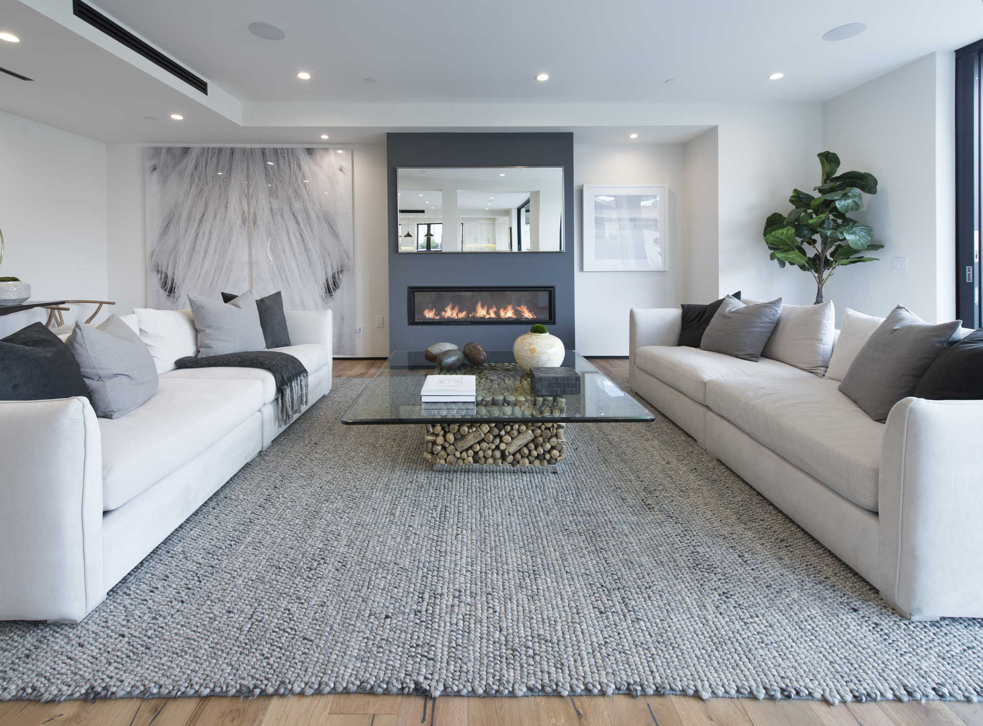 Formal living room with linear gas fireplace and grey accent wall