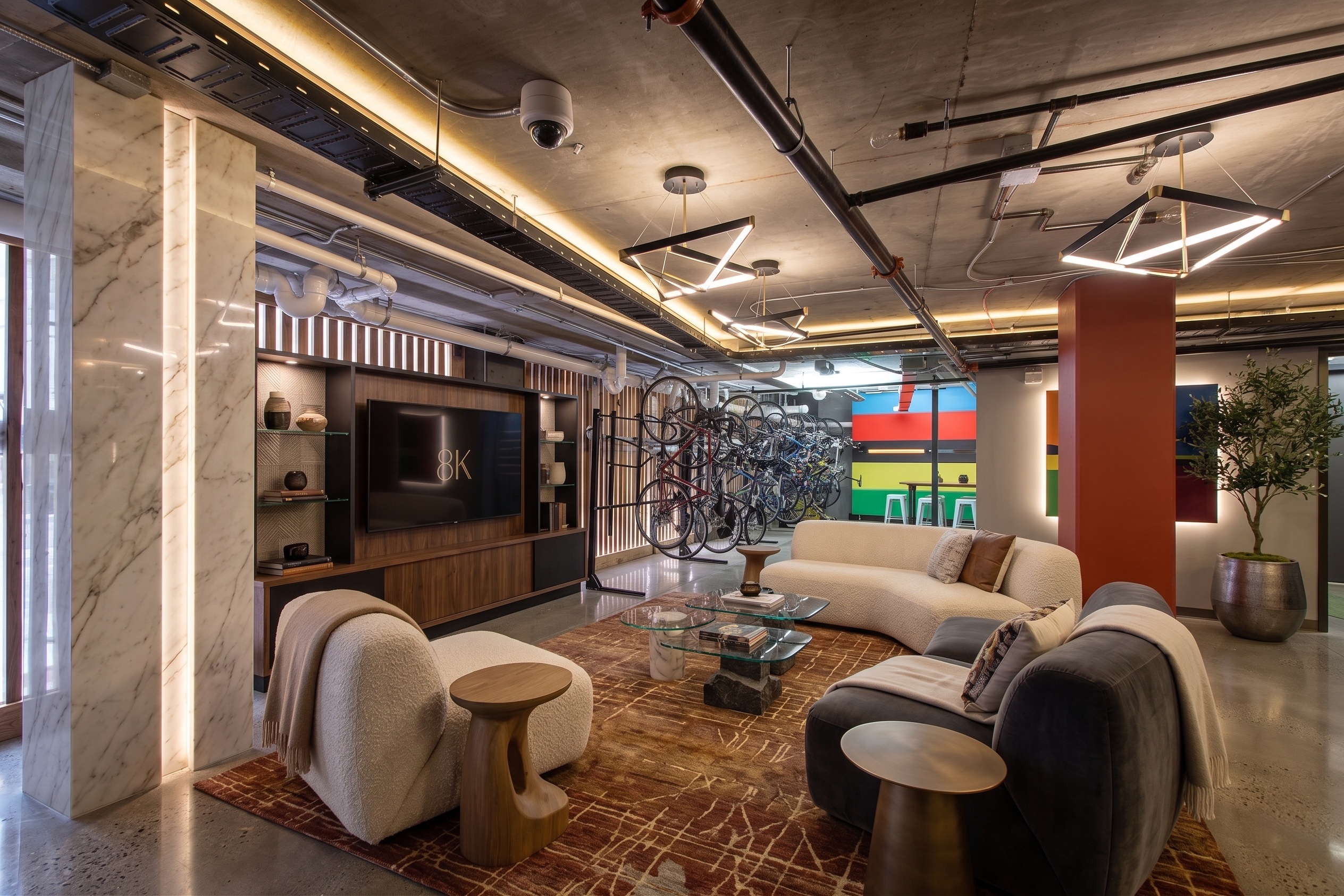 Residents' lounge with marble columns, walnut media wall, and bike feature wall