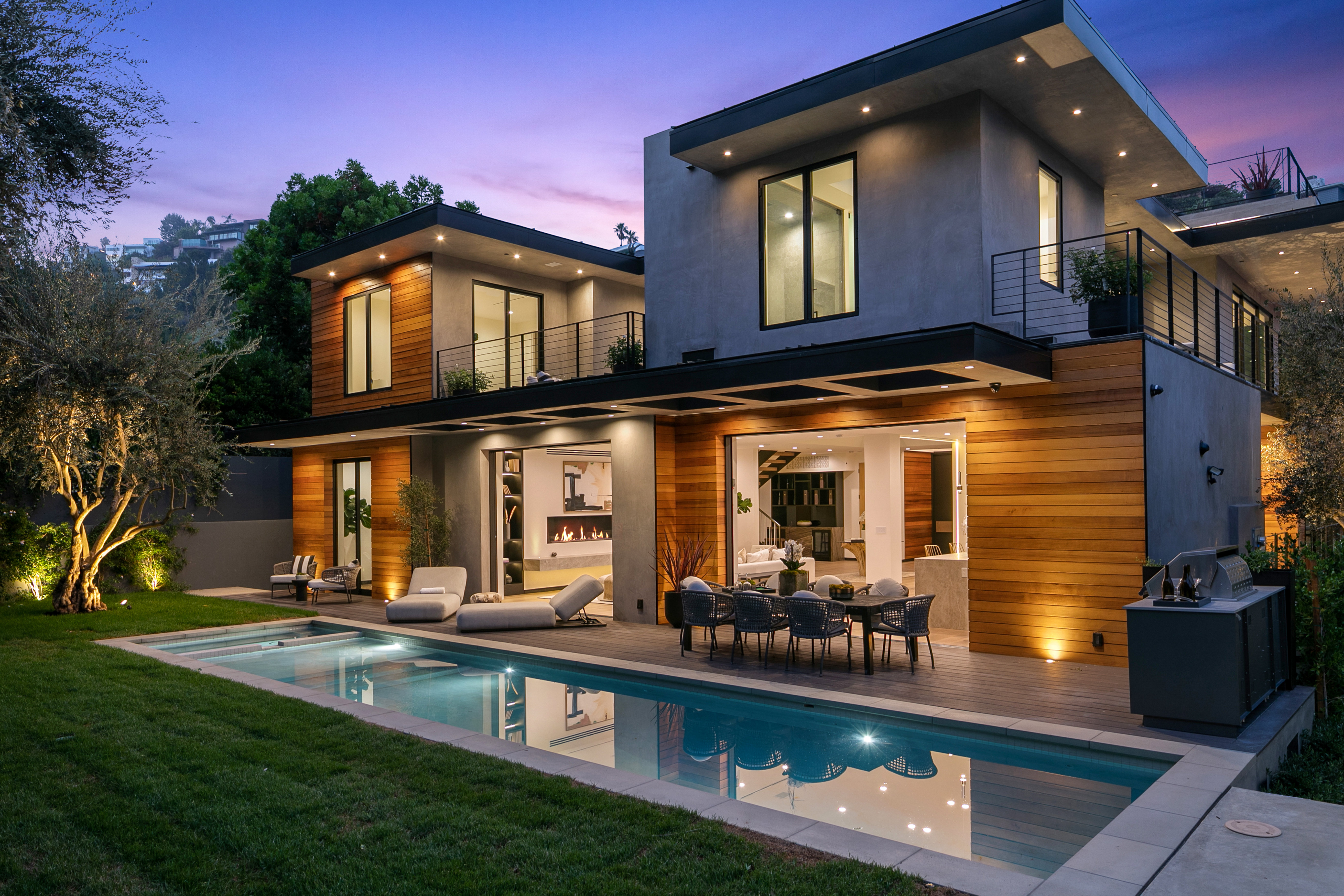 Pool terrace at twilight with city view beyond