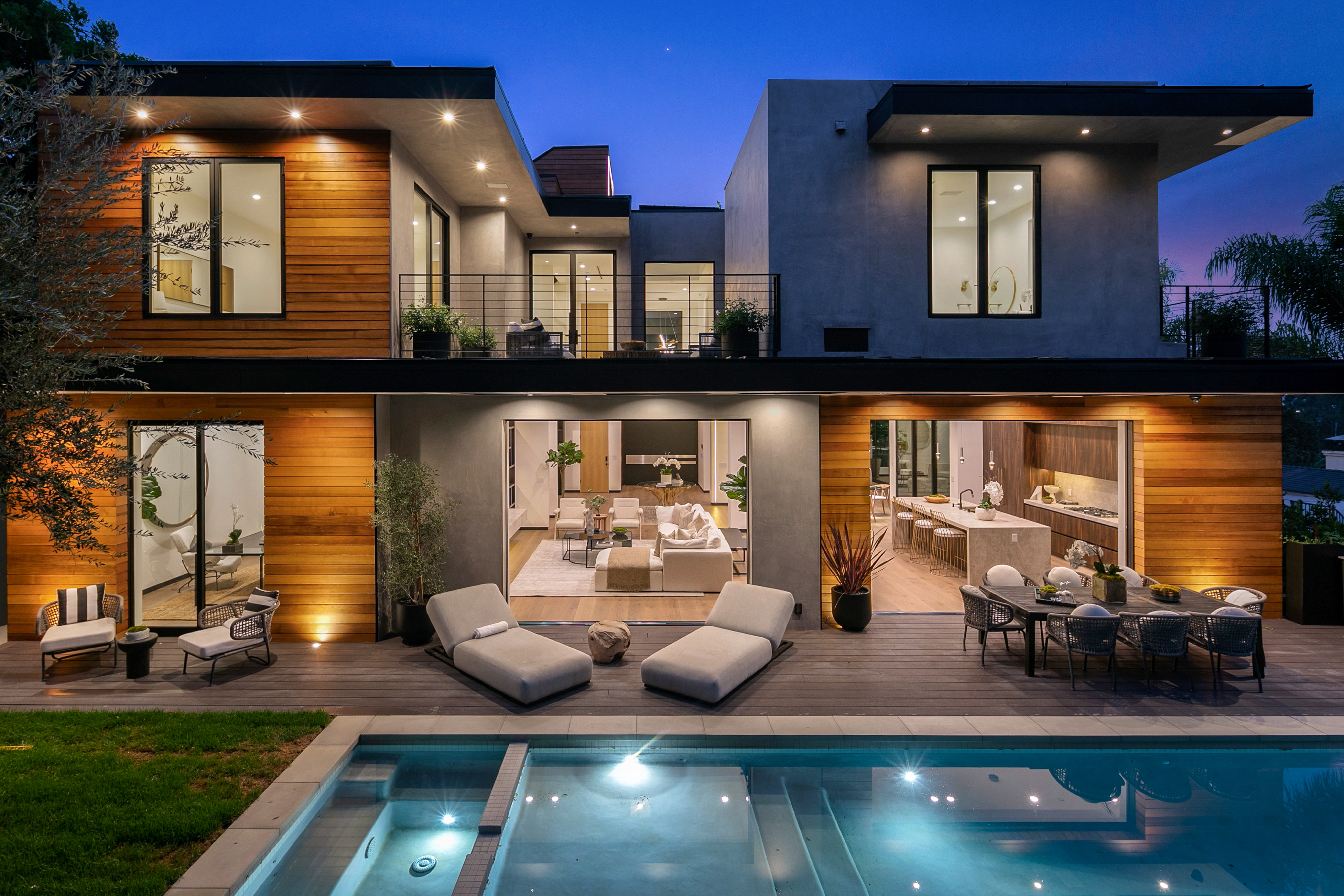 Rear elevation at blue hour with full-height glazing illuminated