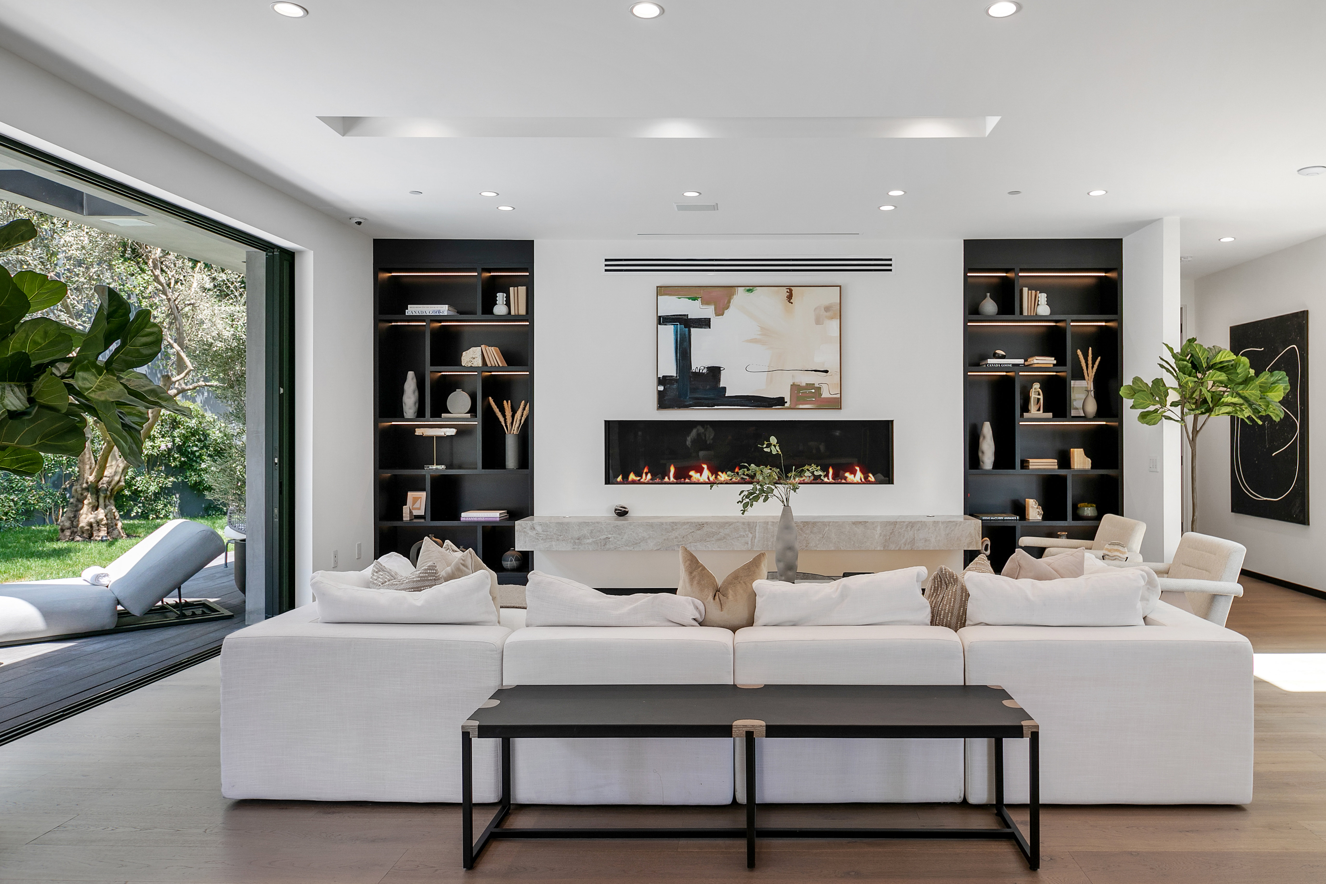 Living room with linear fireplace and full-height glazing