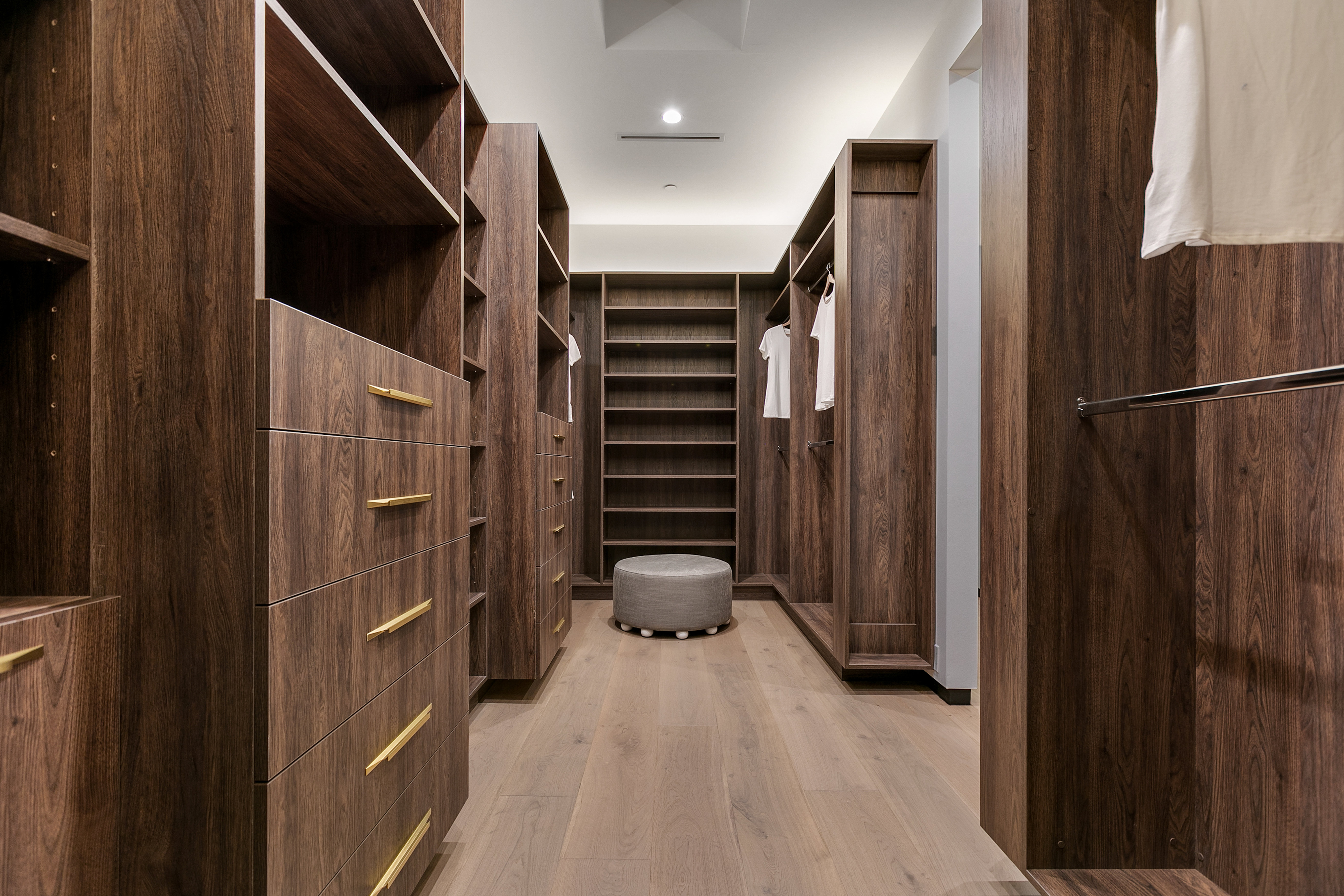Primary walk-in closet with custom millwork