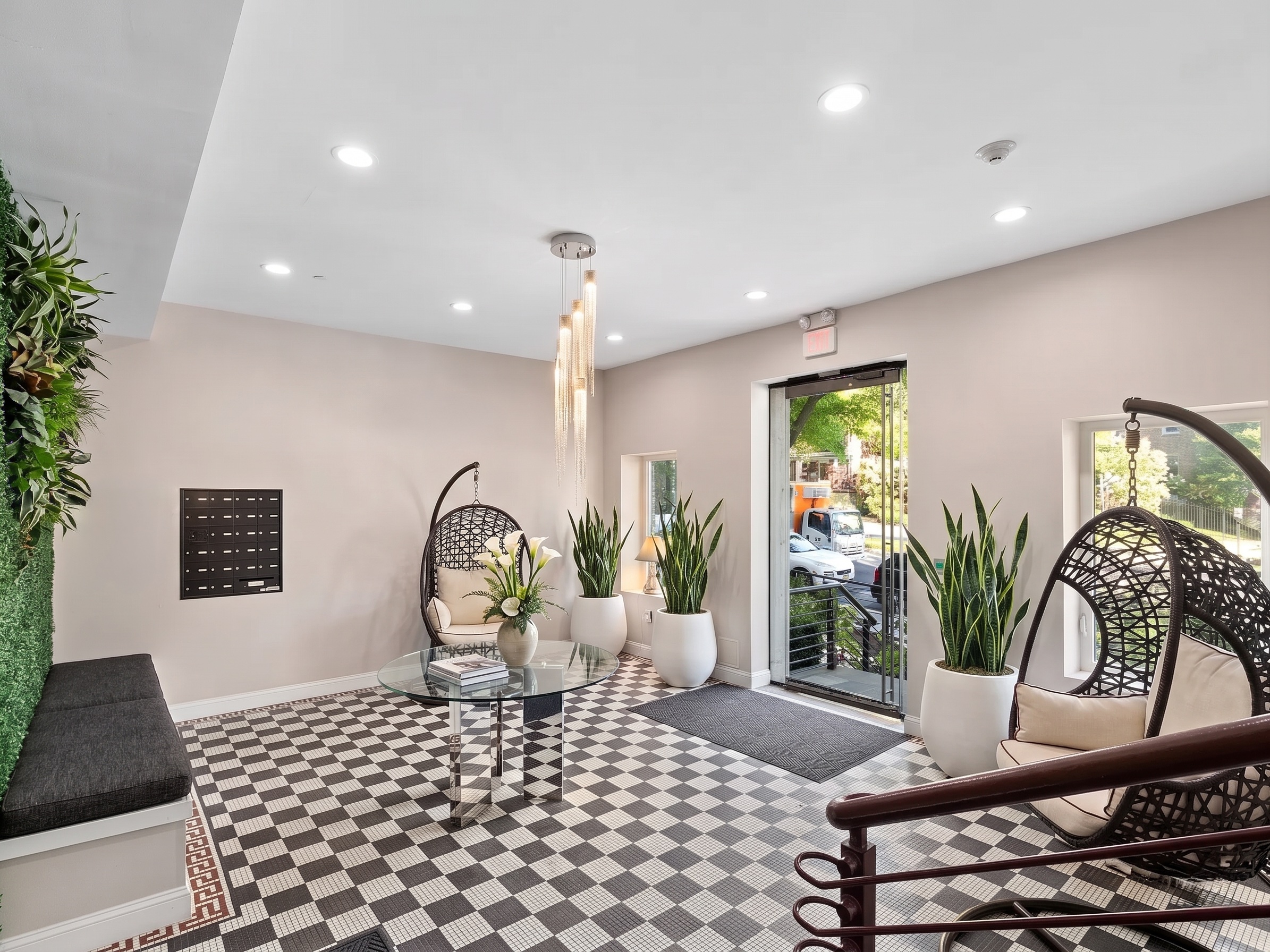 Building lobby with checkerboard mosaic floor and hanging rattan chairs