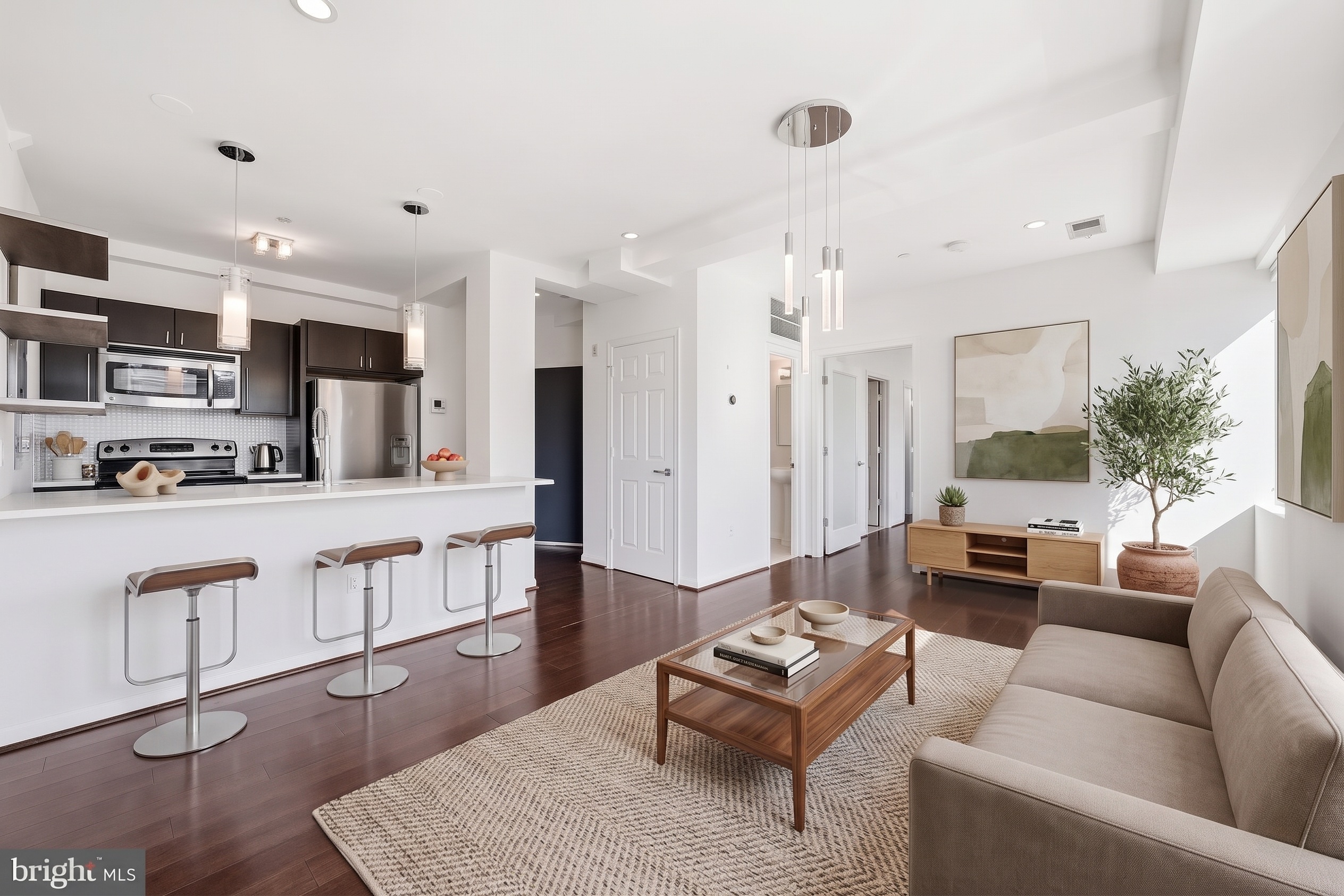 Dining area open to kitchen and living room with wall-mounted TV