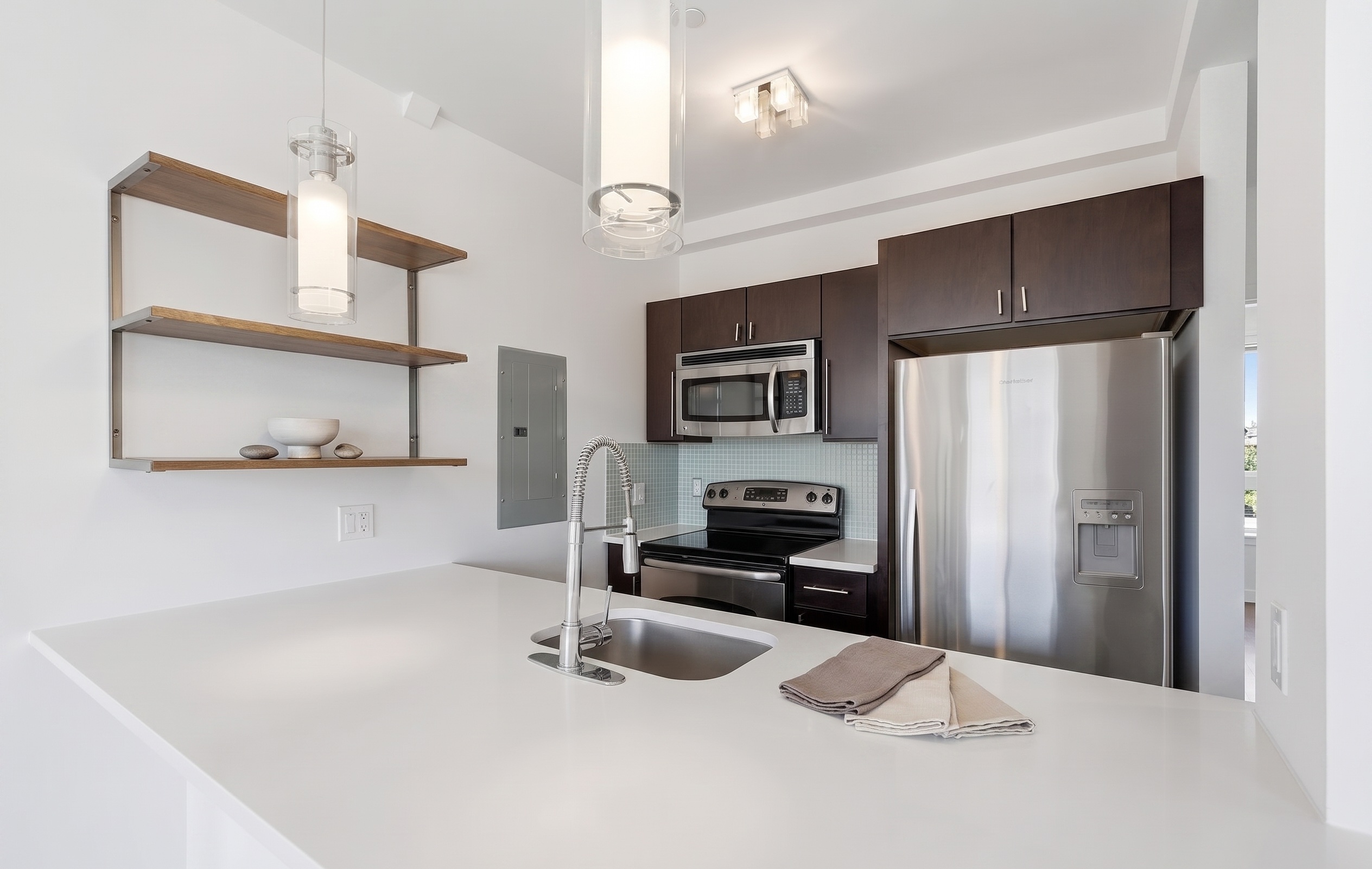 Residence kitchen with dark walnut cabinetry and white quartz countertop